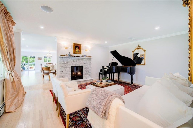78 Schultz Hill Rd, Rhinebeck, NY 12580 - living room featuring light wood-style flooring, a glass covered fireplace, recessed lighting, a baseboard radiator, and crown molding