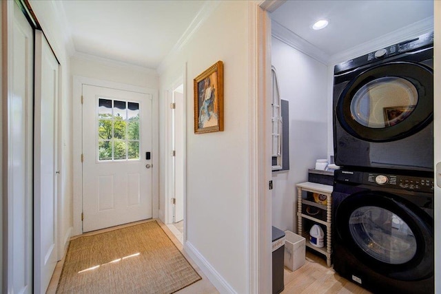 78 Schultz Hill Rd, Rhinebeck, NY 12580 - laundry area featuring stacked washer / drying machine, ornamental molding, baseboards, and light wood-style floors
