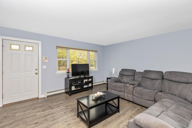 living area with baseboards, wood finished floors, and baseboard heating