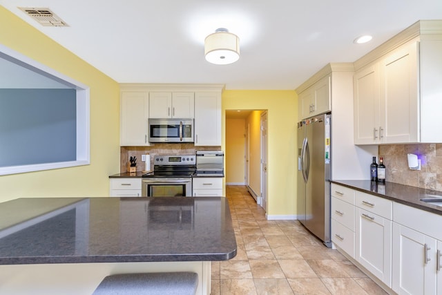 kitchen with backsplash, recessed lighting, stainless steel appliances, and visible vents