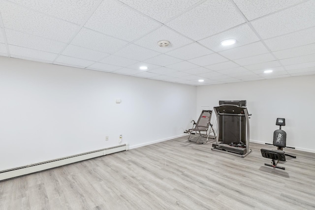 workout area with recessed lighting, baseboards, baseboard heating, and wood finished floors