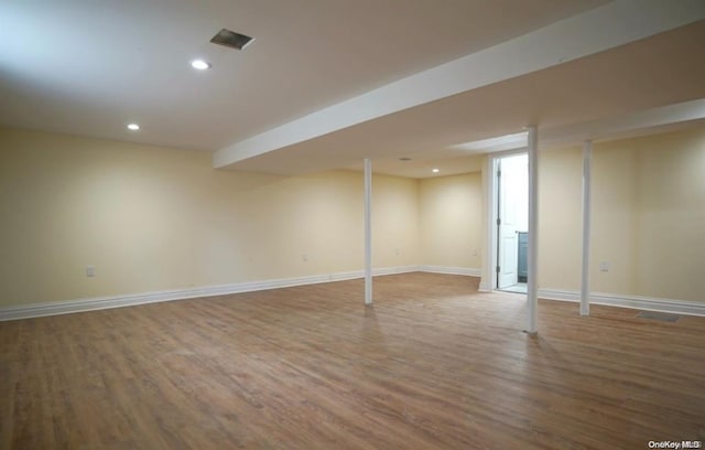 finished basement featuring baseboards, recessed lighting, and wood finished floors