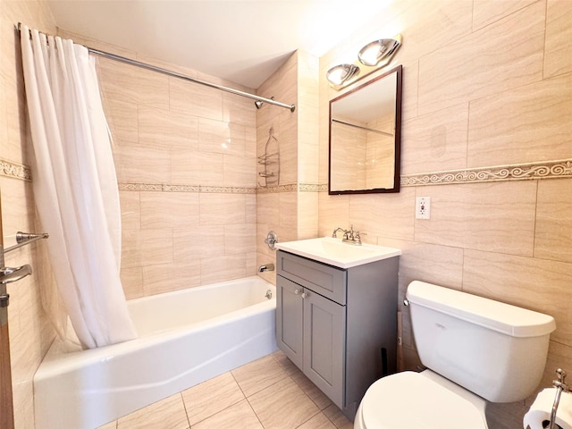 full bathroom with tile walls, tile patterned flooring, shower / tub combo, vanity, and toilet