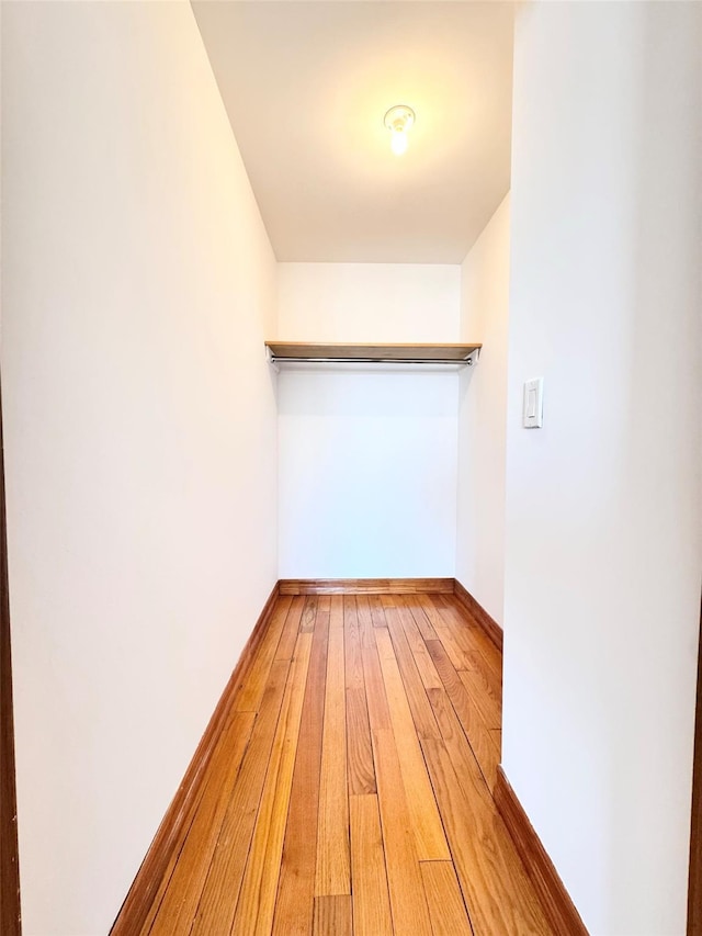 walk in closet with light wood-type flooring