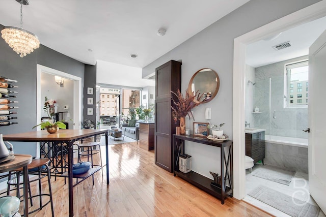 11-24 31st Ave Unit 3A, Astoria, NY 11106 - dining room with light wood-style floors and a chandelier
