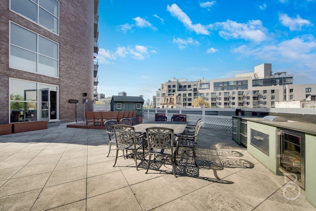 11-24 31st Ave Unit 3A, Astoria, NY 11106 - view of patio / terrace featuring wine cooler, outdoor dining area, and an outdoor kitchen