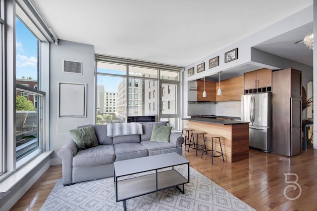 11-24 31st Ave Unit 3A, Astoria, NY 11106 - living room featuring wood finished floors and expansive windows