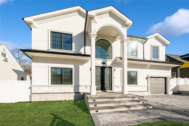 26 Kingston Ave, Hicksville, NY 11801 - view of front facade with a garage, fence, and stucco siding