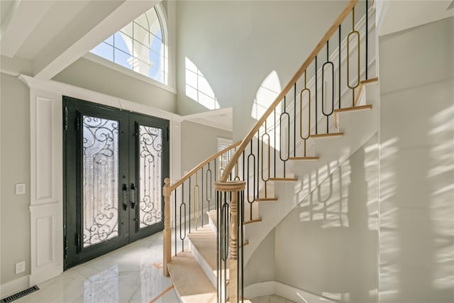 26 Kingston Ave, Hicksville, NY 11801 - entryway with french doors, a towering ceiling, visible vents, baseboards, and stairs