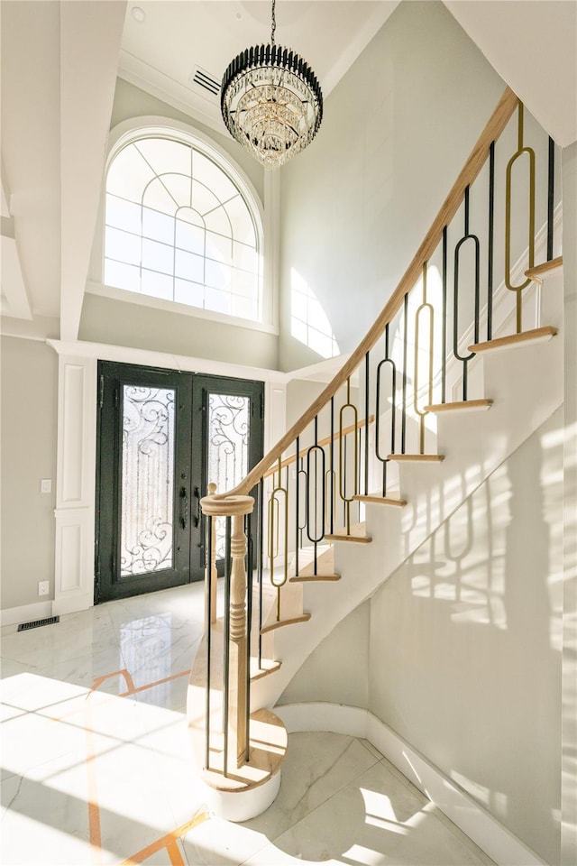 26 Kingston Ave, Hicksville, NY 11801 - entryway with an inviting chandelier, french doors, marble finish floor, baseboards, and visible vents