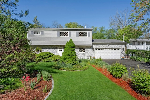 77 Greenwood Ln, White Plains, NY 10607 - view of front of property with stone siding, an attached garage, and asphalt driveway