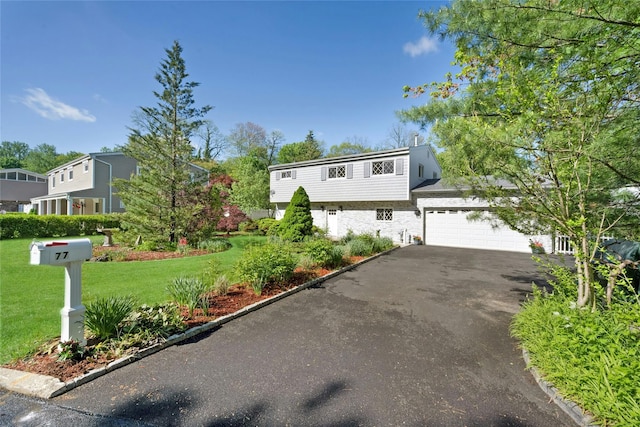 77 Greenwood Ln, White Plains, NY 10607 - colonial house with driveway, a front yard, an attached garage, and stone siding