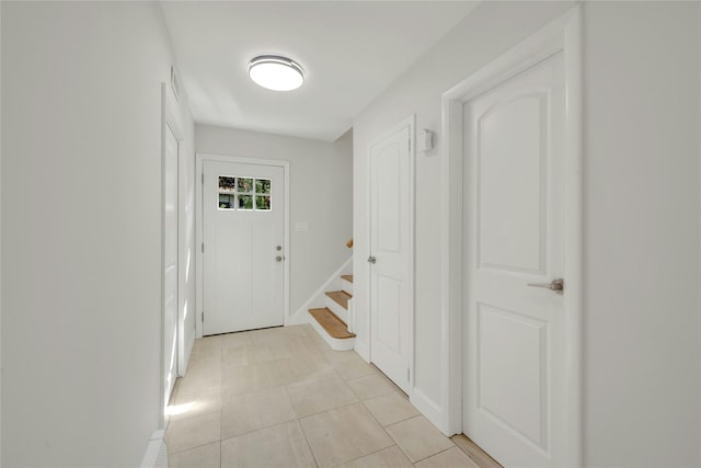 77 Greenwood Ln, White Plains, NY 10607 - corridor featuring stairway, light tile patterned floors, and baseboards