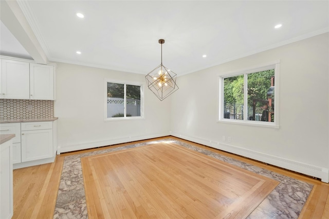77 Greenwood Ln, White Plains, NY 10607 - unfurnished dining area with ornamental molding, light wood-style floors, recessed lighting, a chandelier, and baseboards