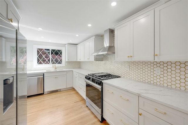 77 Greenwood Ln, White Plains, NY 10607 - kitchen with wall chimney exhaust hood, appliances with stainless steel finishes, backsplash, a sink, and white cabinetry