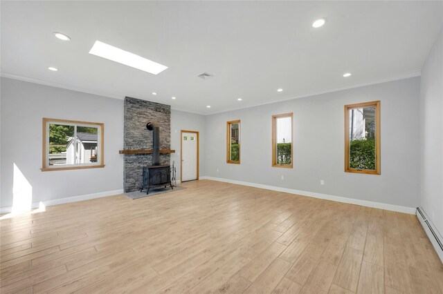 77 Greenwood Ln, White Plains, NY 10607 - unfurnished living room featuring a wood stove, light wood finished floors, crown molding, baseboard heating, and baseboards