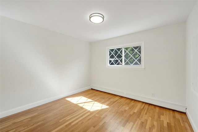 77 Greenwood Ln, White Plains, NY 10607 - empty room featuring a baseboard radiator, wood finished floors, and baseboards