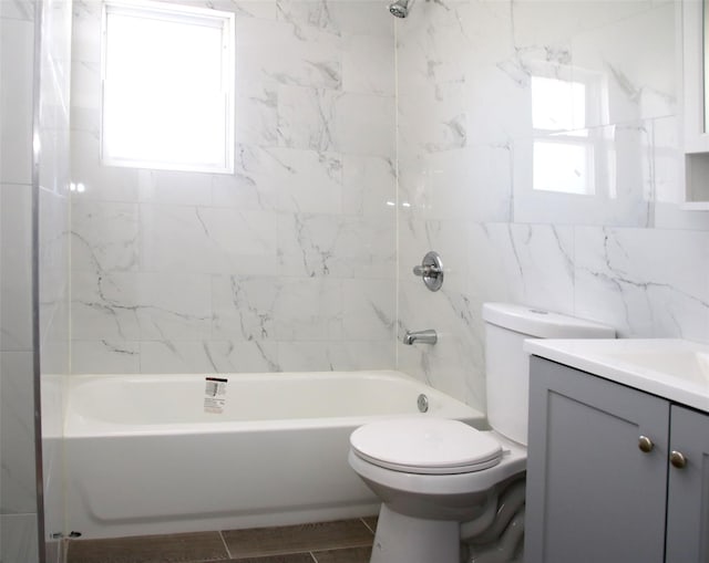 full bathroom featuring vanity, shower / tub combination, toilet, and tile walls