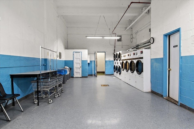 garage with washing machine and clothes dryer and a garage door opener