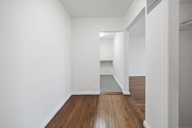 walk in closet with wood finished floors