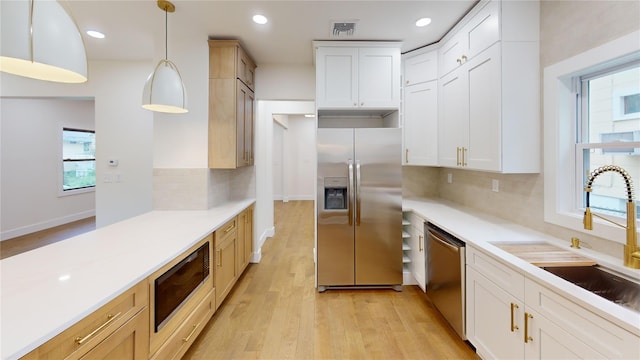250 Cedar Hill Ave, Nyack, NY 10960 - kitchen featuring light wood finished floors, light countertops, stainless steel appliances, and a sink