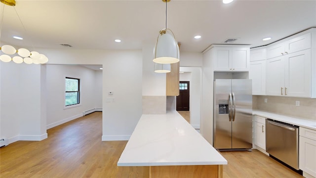 250 Cedar Hill Ave, Nyack, NY 10960 - kitchen with a peninsula, light wood-type flooring, light countertops, appliances with stainless steel finishes, and a baseboard radiator
