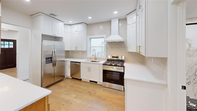 250 Cedar Hill Ave, Nyack, NY 10960 - kitchen featuring a sink, stainless steel appliances, wall chimney exhaust hood, white cabinetry, and light wood-style floors