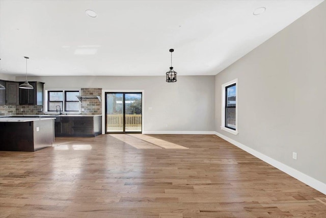 169 Bretton Rd, Yonkers, NY 10710 - unfurnished dining area with recessed lighting, baseboards, a sink, and light wood finished floors