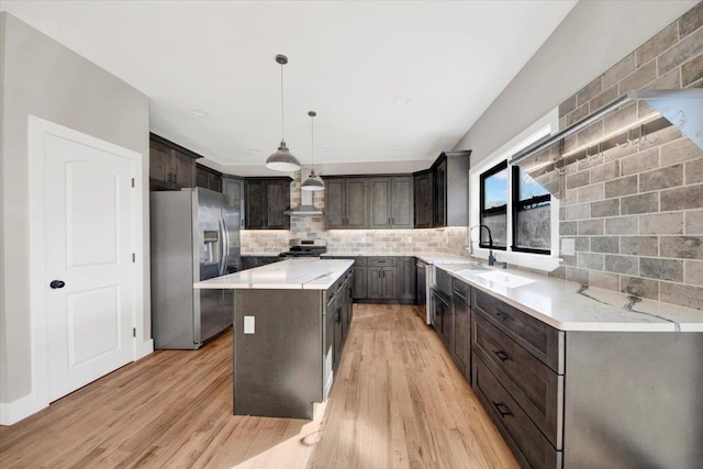 169 Bretton Rd, Yonkers, NY 10710 - kitchen with light wood-type flooring, dark brown cabinetry, and stainless steel appliances