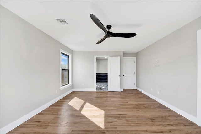 169 Bretton Rd, Yonkers, NY 10710 - unfurnished bedroom with visible vents, wood finished floors, baseboards, ceiling fan, and connected bathroom