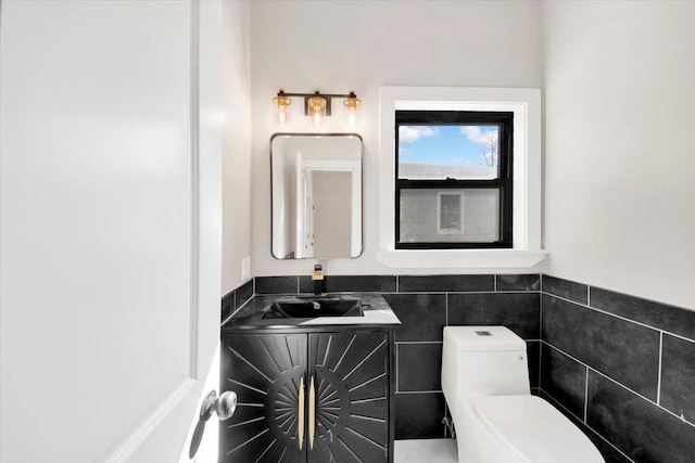 169 Bretton Rd, Yonkers, NY 10710 - bathroom featuring vanity, a wainscoted wall, toilet, and tile walls