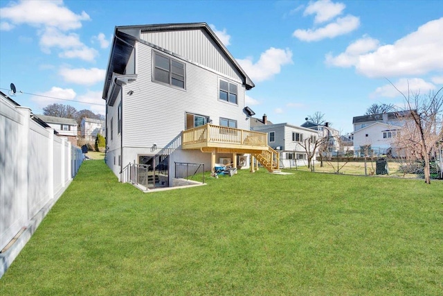 169 Bretton Rd, Yonkers, NY 10710 - back of property with a wooden deck, a fenced backyard, board and batten siding, a lawn, and stairway