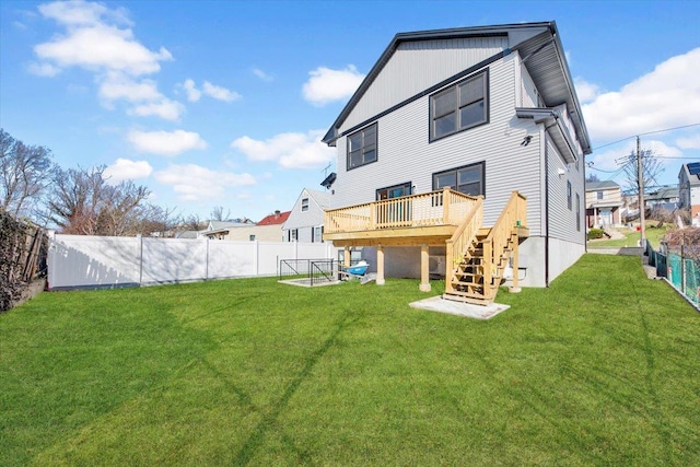 169 Bretton Rd, Yonkers, NY 10710 - back of property with a yard, a deck, stairs, and a fenced backyard