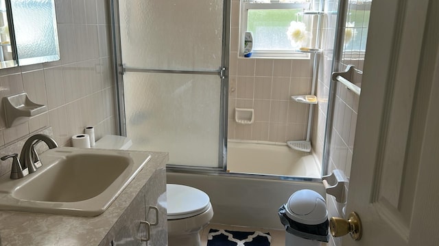 850 First Ave, Franklin Square, NY 11010 - bathroom featuring toilet, tile walls, enclosed tub / shower combo, vanity, and decorative backsplash