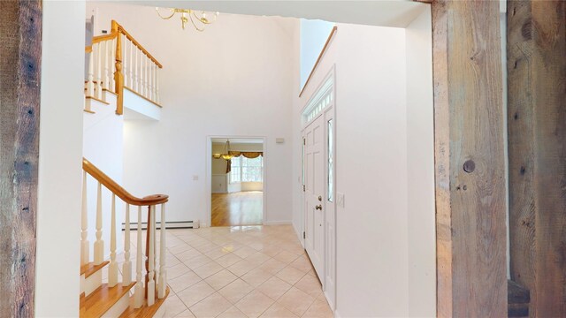 11 Hidden Meadow Rd, Warwick, NY 10990 - entryway featuring baseboard heating, stairs, light tile patterned floors, and a chandelier