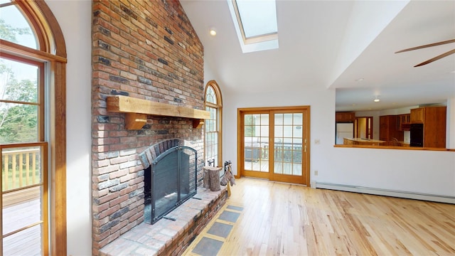 11 Hidden Meadow Rd, Warwick, NY 10990 - unfurnished living room featuring plenty of natural light, a brick fireplace, light wood-type flooring, a skylight, and recessed lighting