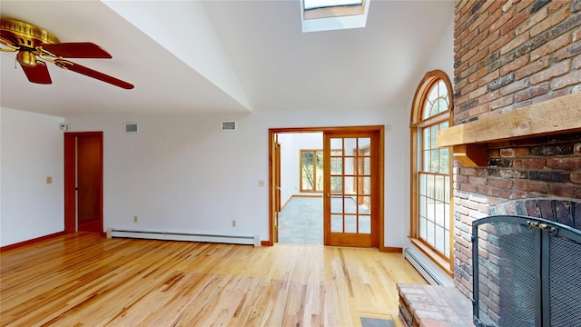 11 Hidden Meadow Rd, Warwick, NY 10990 - unfurnished living room featuring baseboard heating, wood finished floors, a skylight, a ceiling fan, and lofted ceiling