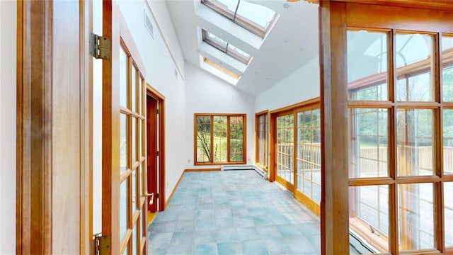 11 Hidden Meadow Rd, Warwick, NY 10990 - unfurnished sunroom with high vaulted ceiling, baseboard heating, and a skylight