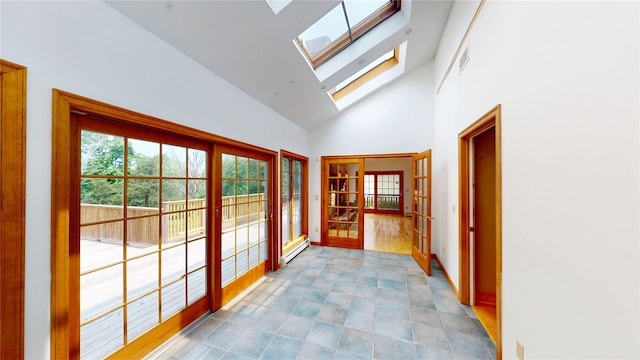 11 Hidden Meadow Rd, Warwick, NY 10990 - doorway with high vaulted ceiling, a baseboard heating unit, a skylight, and french doors