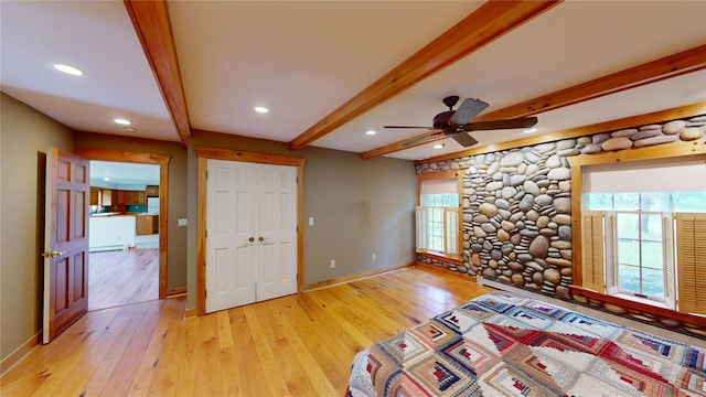 11 Hidden Meadow Rd, Warwick, NY 10990 - unfurnished bedroom featuring light wood-style floors, beam ceiling, recessed lighting, rustic walls, and a closet