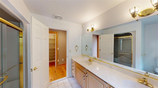 11 Hidden Meadow Rd, Warwick, NY 10990 - bathroom featuring double vanity, a shower with door, tile patterned floors, and a walk in closet