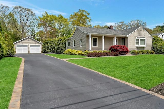 single story home with a detached garage, an outdoor structure, a chimney, and a front yard