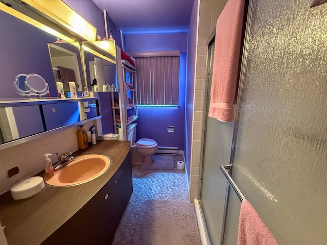 bathroom featuring vanity, toilet, baseboard heating, tasteful backsplash, and a shower stall