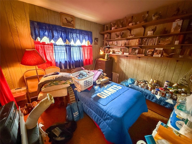 bedroom with carpet floors and wood walls