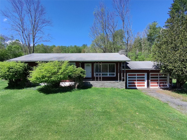 41 Brook Rd, Cochecton, NY 12726 - view of front of house with driveway, a front lawn, a chimney, a garage, and stone siding