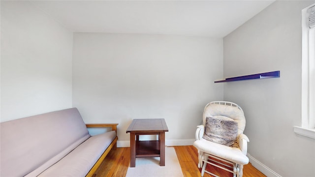 sitting room featuring baseboards and wood finished floors