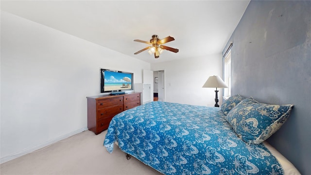 bedroom with light colored carpet and a ceiling fan