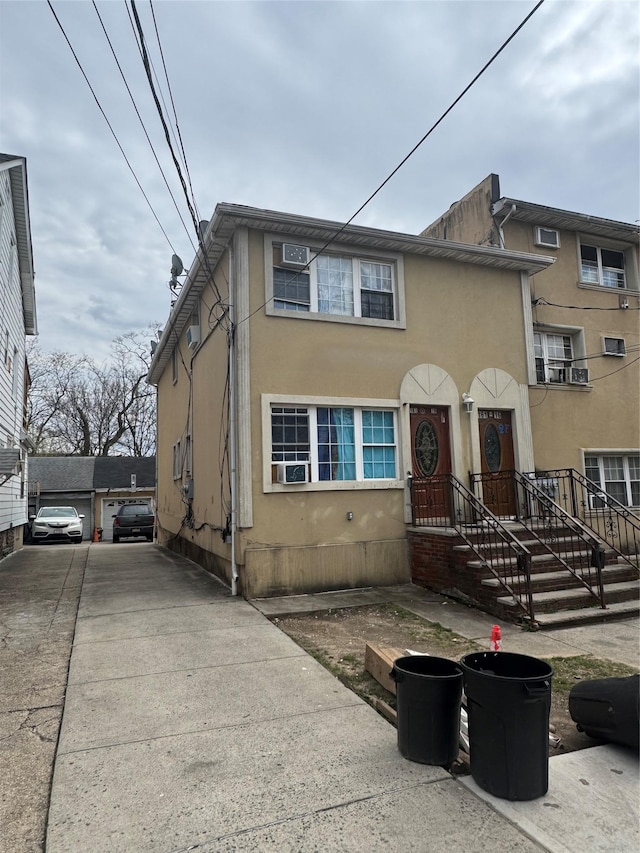 view of property with stucco siding and cooling unit