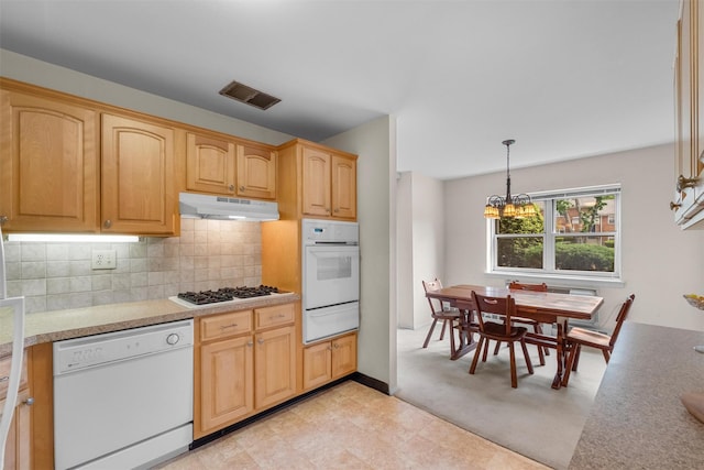 1 Lakeview Dr Unit 1L, Peekskill, NY 10566 - kitchen with white appliances, under cabinet range hood, a chandelier, backsplash, and light countertops