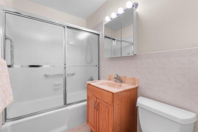 1 Lakeview Dr Unit 1L, Peekskill, NY 10566 - full bath with shower / bath combination with glass door, tile walls, toilet, and vanity
